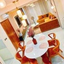 Why choose a short let when in Lagos Living room of brown unit at Rias Apartments Lekki